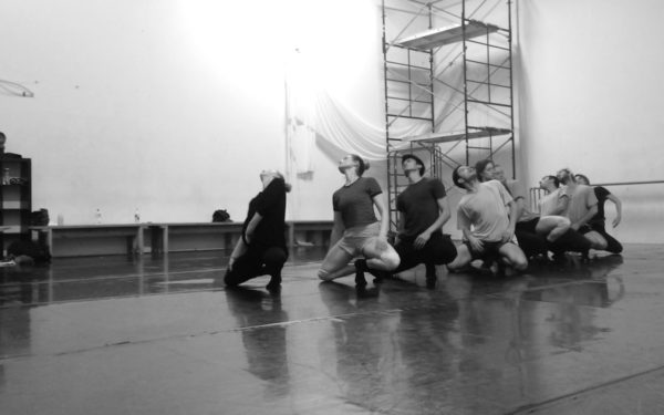 Dancers kneel on the floor