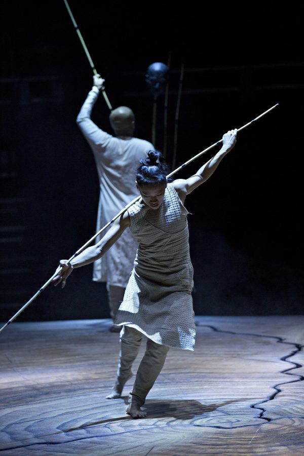 Dancers in white with staffs