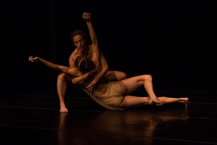 A man holds a woman off the floor