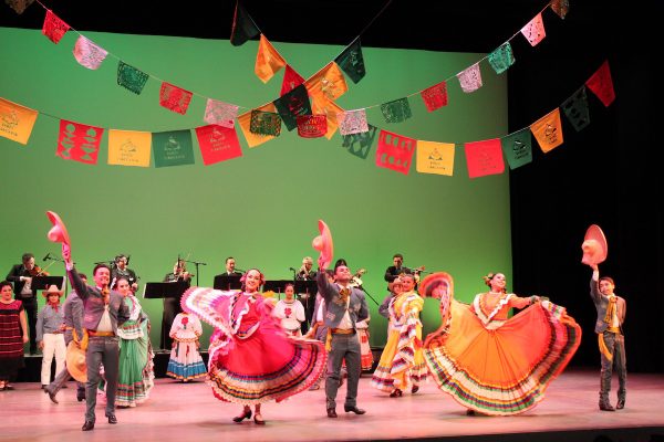 Dancers underneath Mexican banner