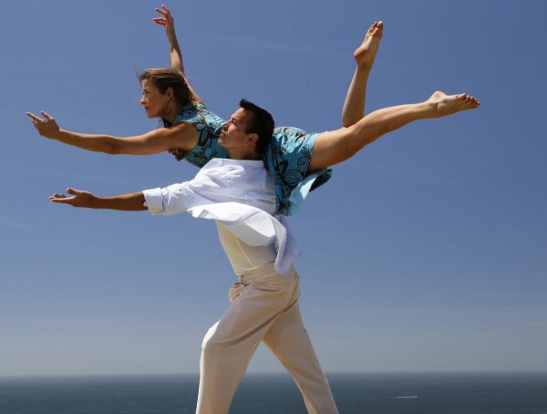 A man lifts a woman on his shoulder