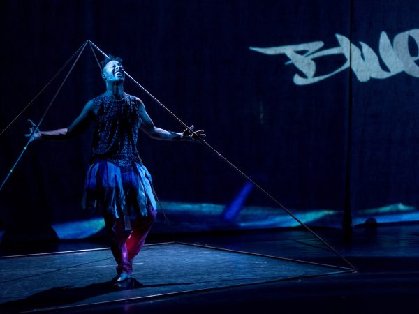 A man on a blue stage