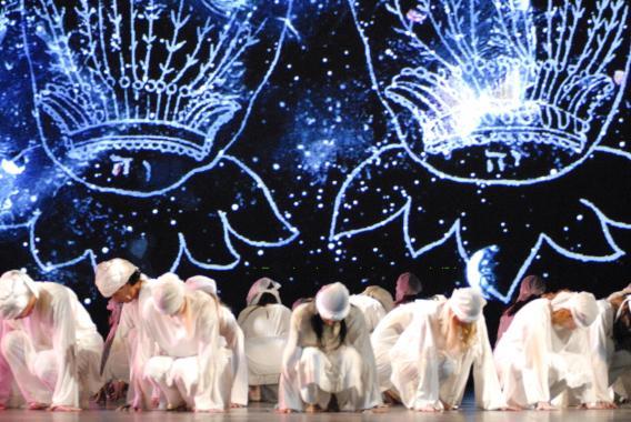 Dancers in white crouch