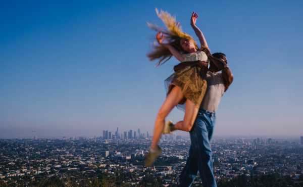 A man lifts a woman with long hair