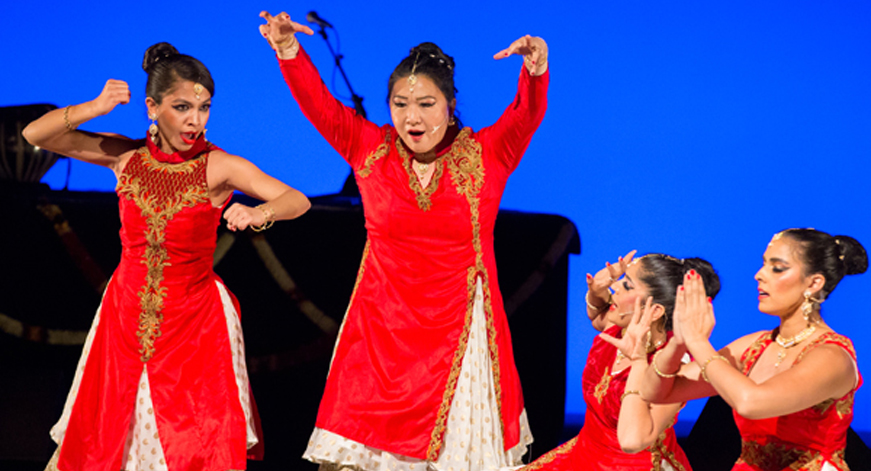Dancers in red take poses