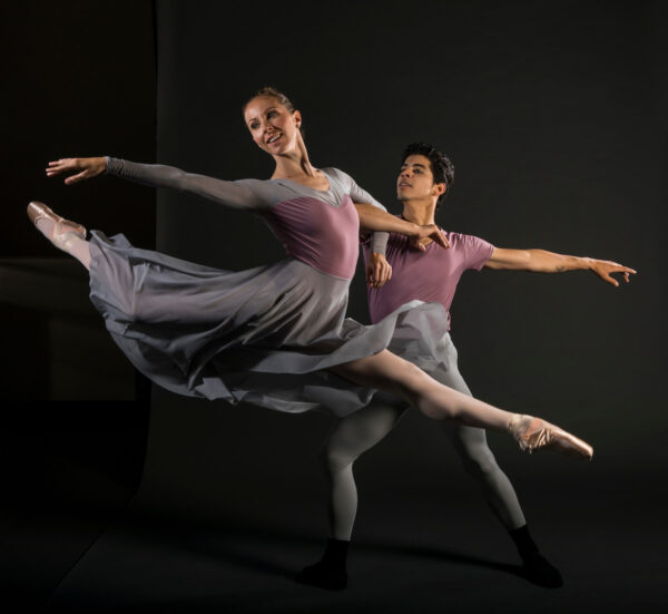 A male dancer lifts a female dancer