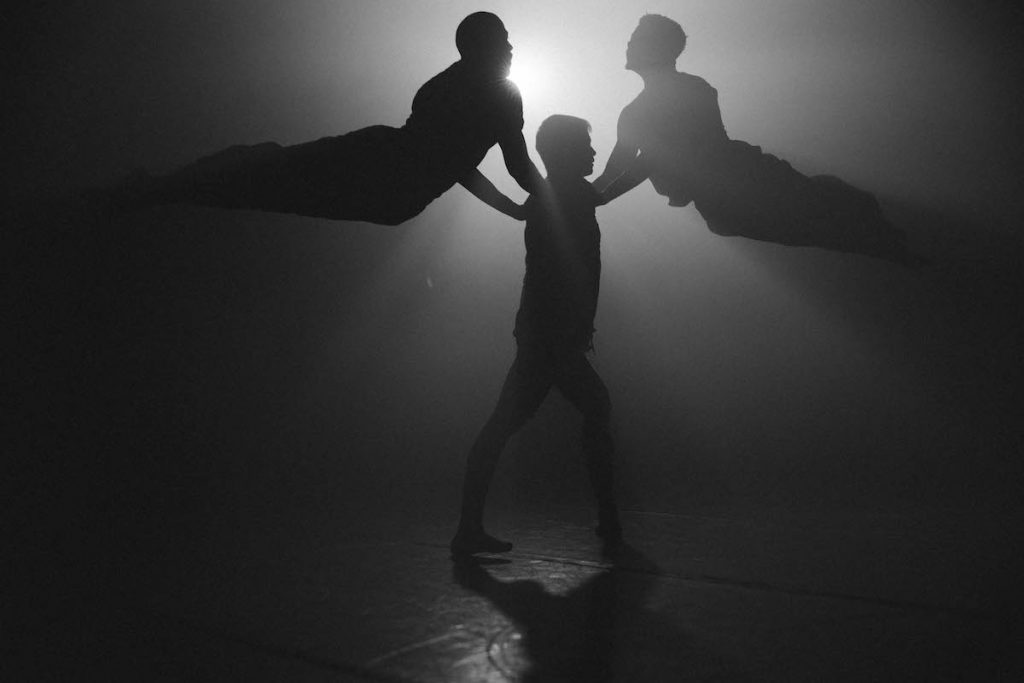 Three backlit dancers