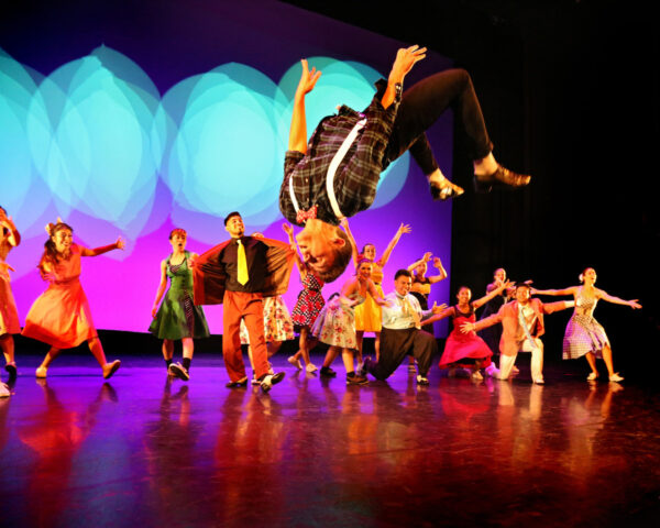 A dancer does a back flip