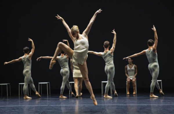 Dancers in white against black background