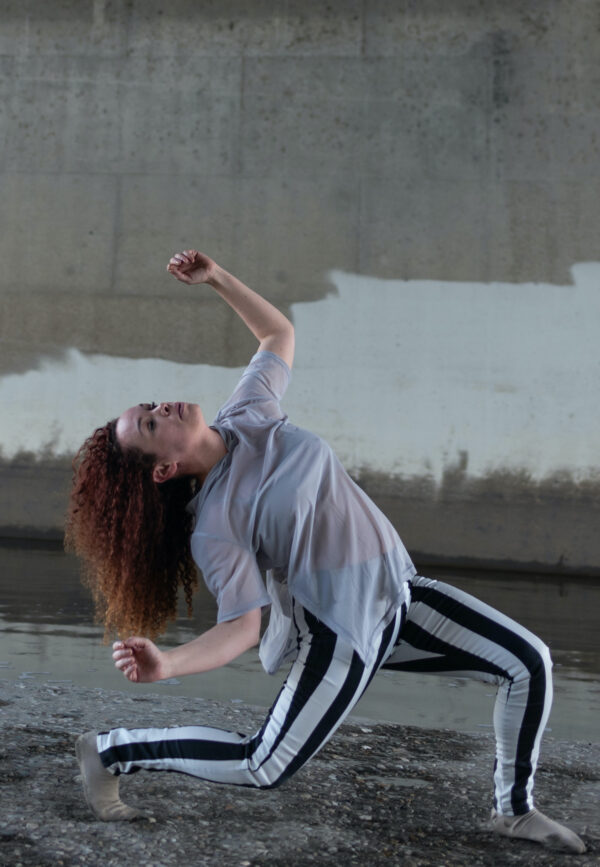 A woman in black and white bends backwards