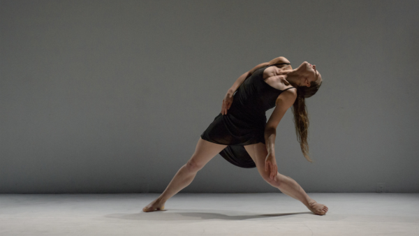 woman in black dress bending backwards