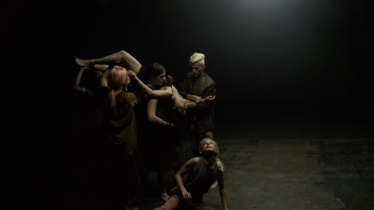 A group of dancers in shadows