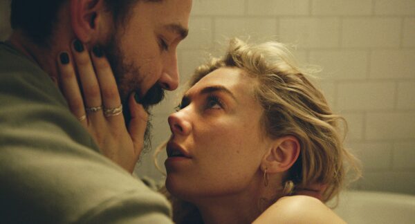 A screenshot from the film Pieces of a Woman of two characters in a bathtub, the actress Vanessa Kirby with her hand caressing the face of actor Shia LaBeouf