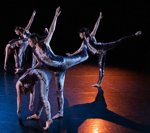 Dancers in silver jumpsuits