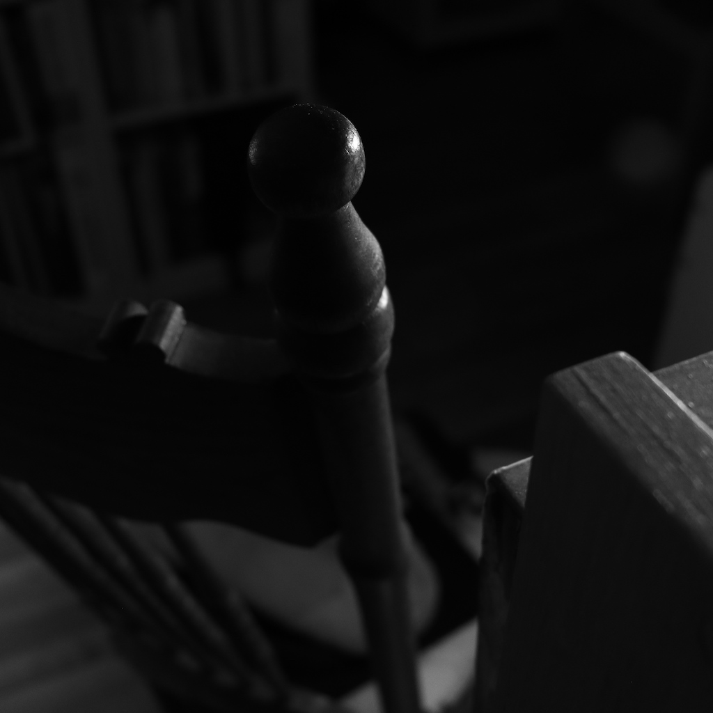feather-lit of chair back at night