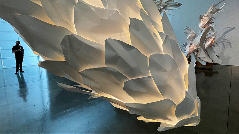 A huge lamp that resembles a white artichoke, with layers and layers of leaves.