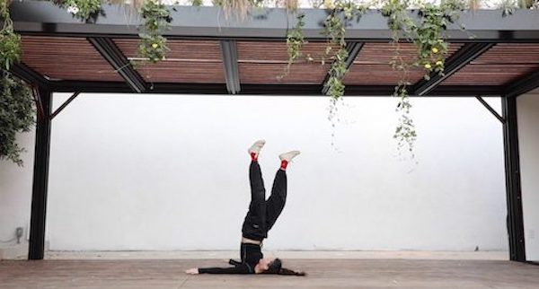 A woman extends her leg into the air