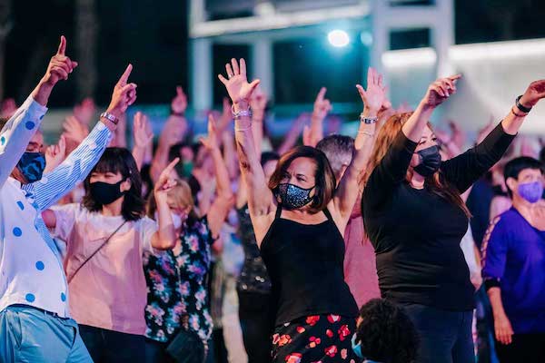 A group of dancers with hands in air