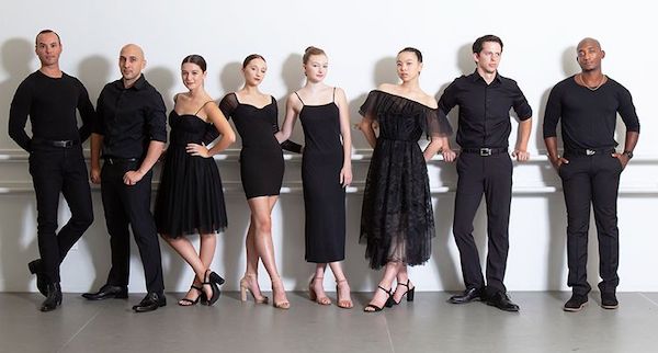 Eight dancers in cocktail attire pose