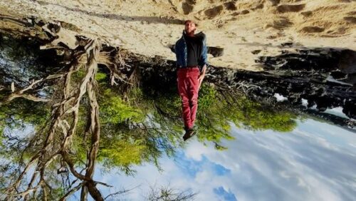 A man stands on his head with the picture upside down