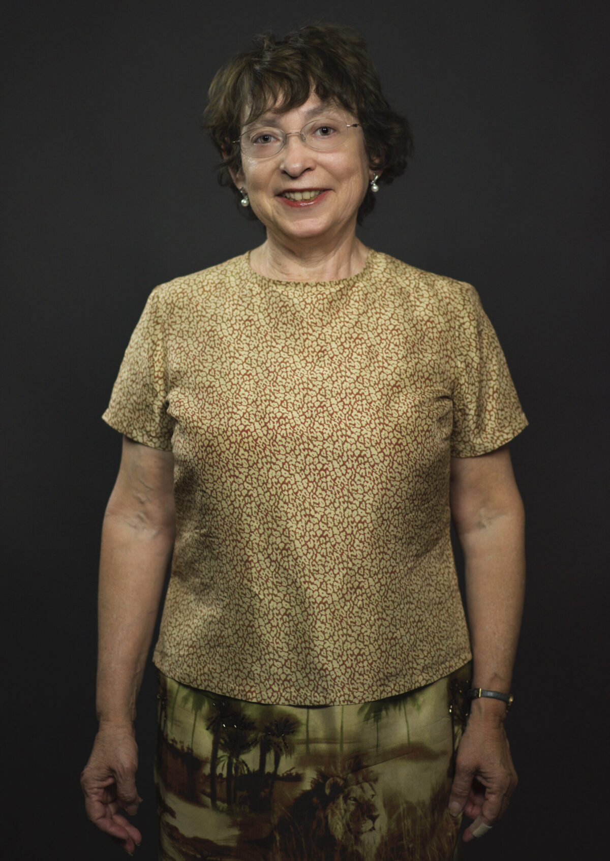 Poet Robbi Nestor with short brown hair. She wears a leopard t-shirt and camouflage pants. 