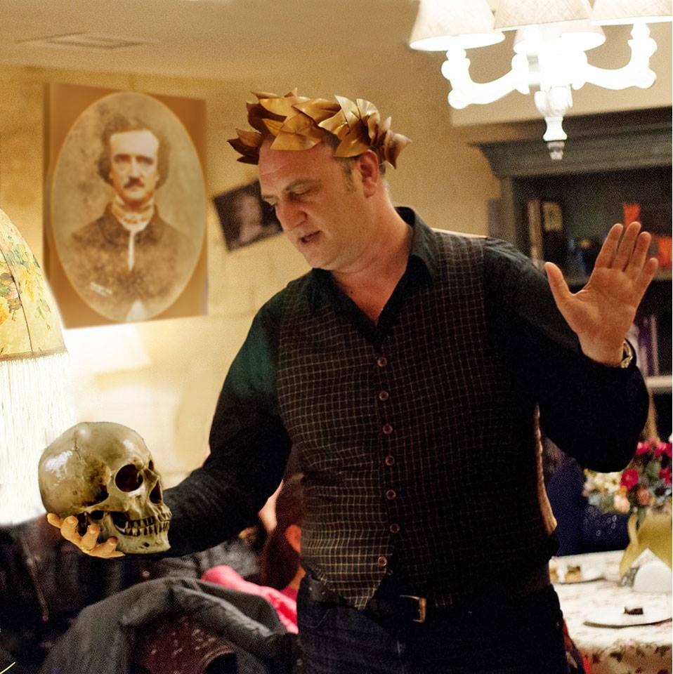 Photo of poet David Dephy holding a skull as if he's communicating with it and a photo of Edgar Allan Poe in the background.