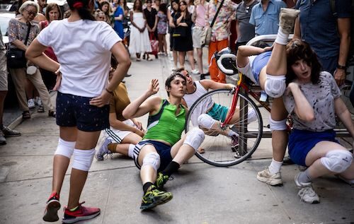 people on the ground with a bicycle