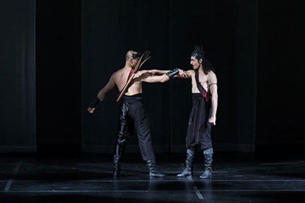 A moment from The Scarlet Stone where two men face each other, arrows hanging on their backs.