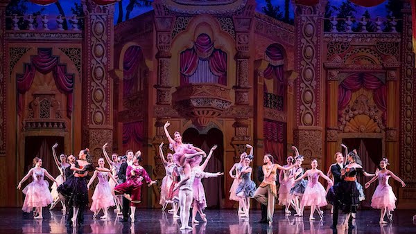 Dancers in front of an elaborate palace