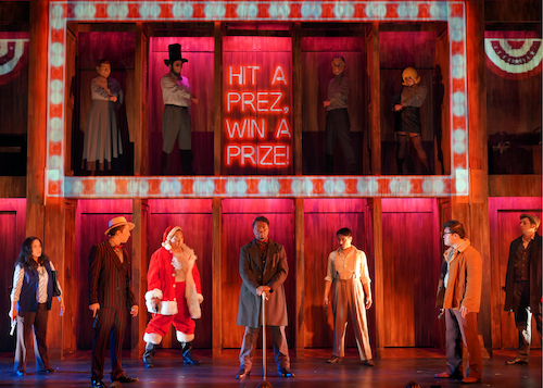 A group in different costumes fill the stage