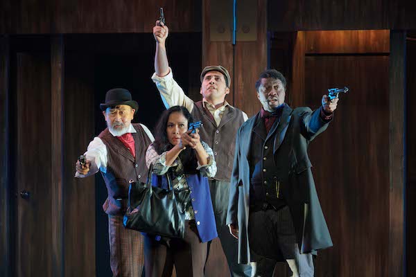 Four actors holding guns in Assassins