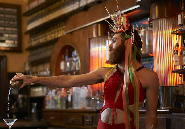 A bearded man pours a drink