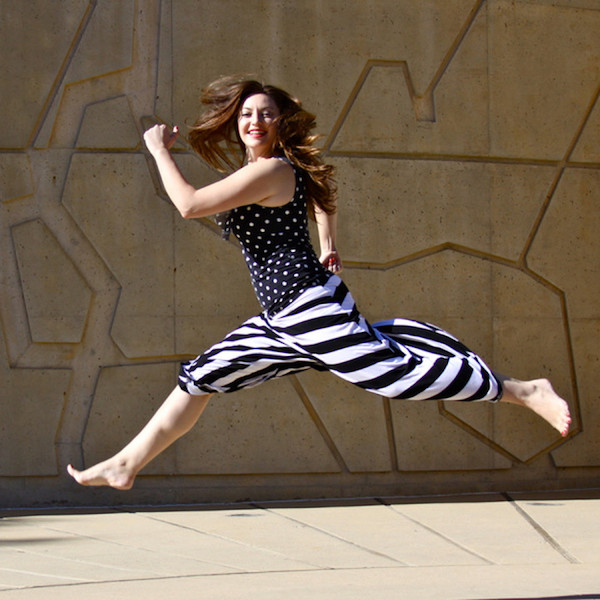 A dancer in a striped skirt jumps