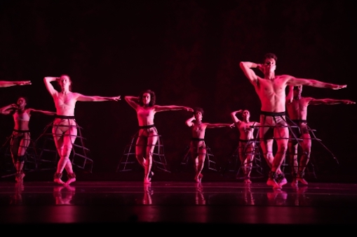 Several dancers in red light
