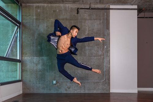 A man in a dark suit jumps in the area