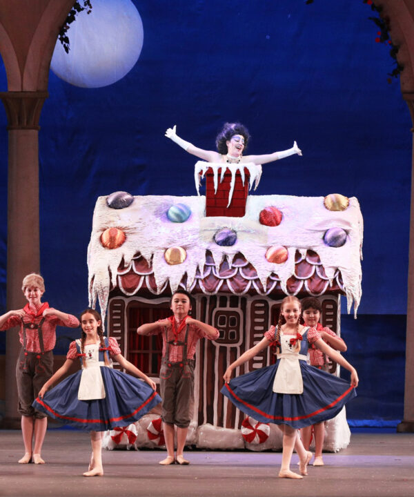 A woman in a chimney with children dancing