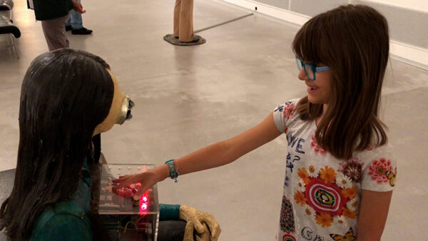 Girl playing with a sculpture
