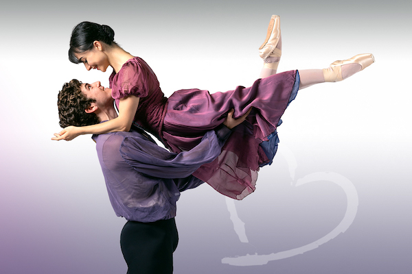 A man lifts a woman in purple