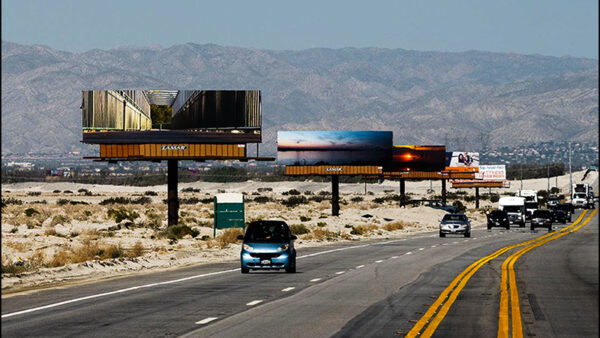 A raw of billboards with photos