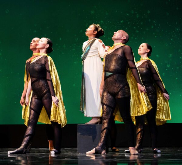 A group of dancers stares at the sky