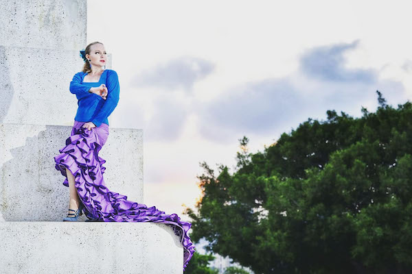 A flamenco dancer in purple and b lue