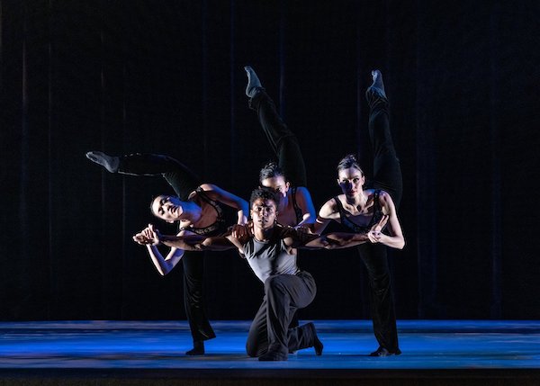A group of dancers crouch