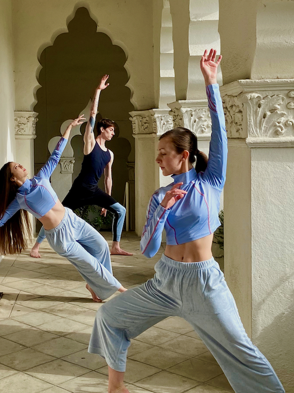 Dancers pose in a walkway