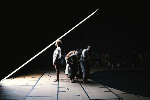 Figures crouching and one standing