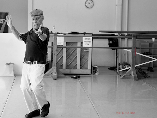 A man in white pants and a cap