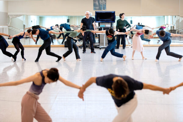 A group of dancers join hands