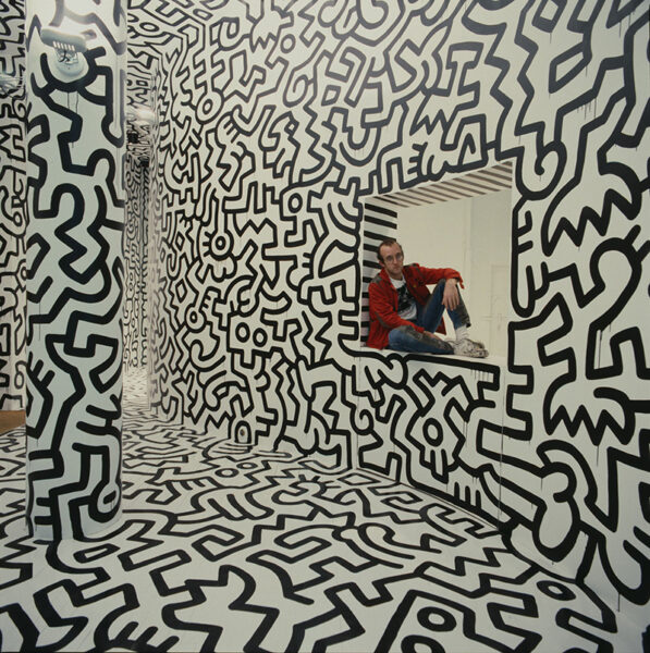 Keith Haring sitting on a window