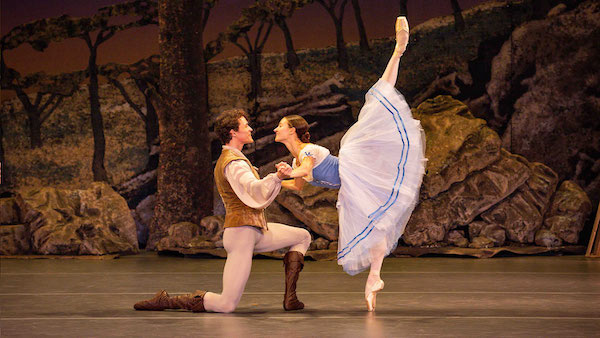 A man supports a ballerina in arabesque