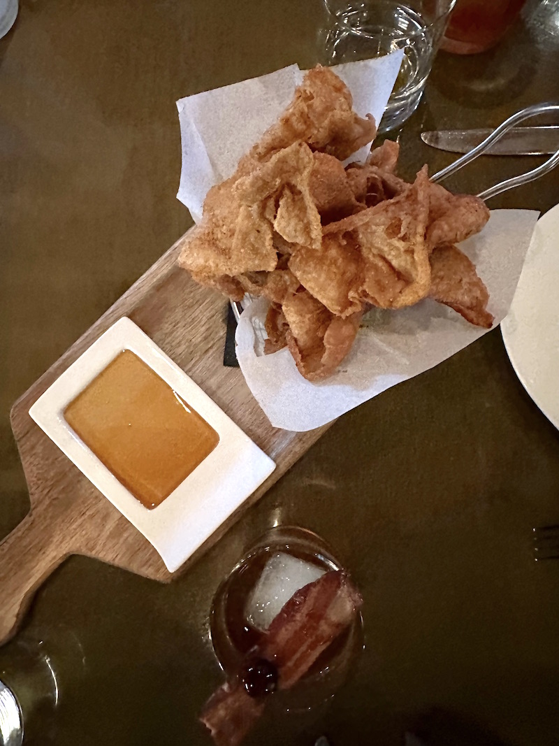 Crispy Chicken Skins served with smokey honey