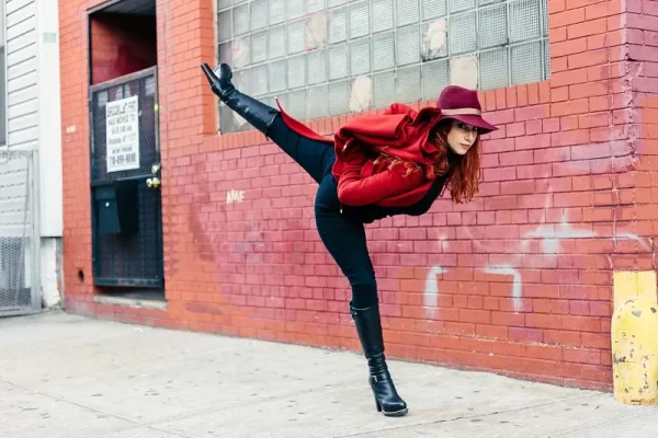 A lady in a red jacket and hat